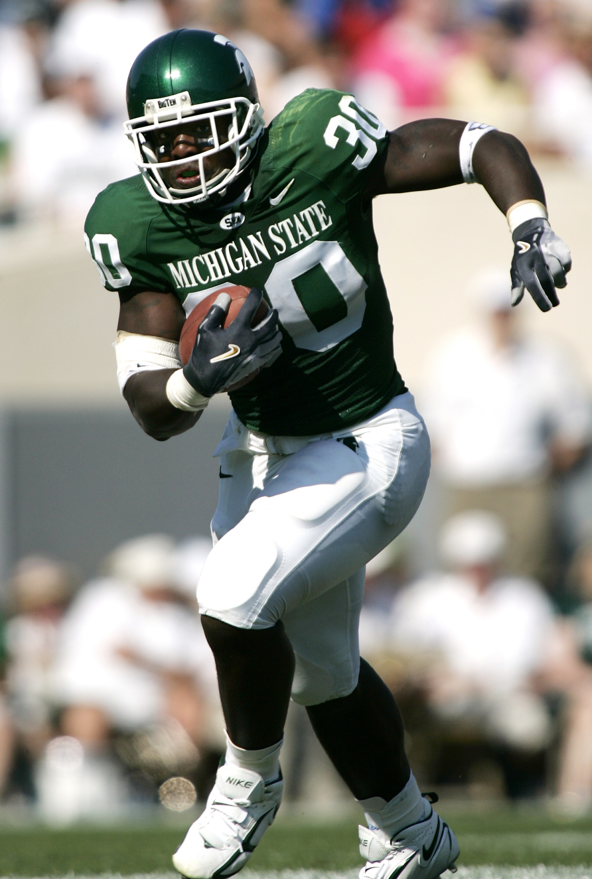 Jehuu Caulcrick #30 running with the ball for Michigan State