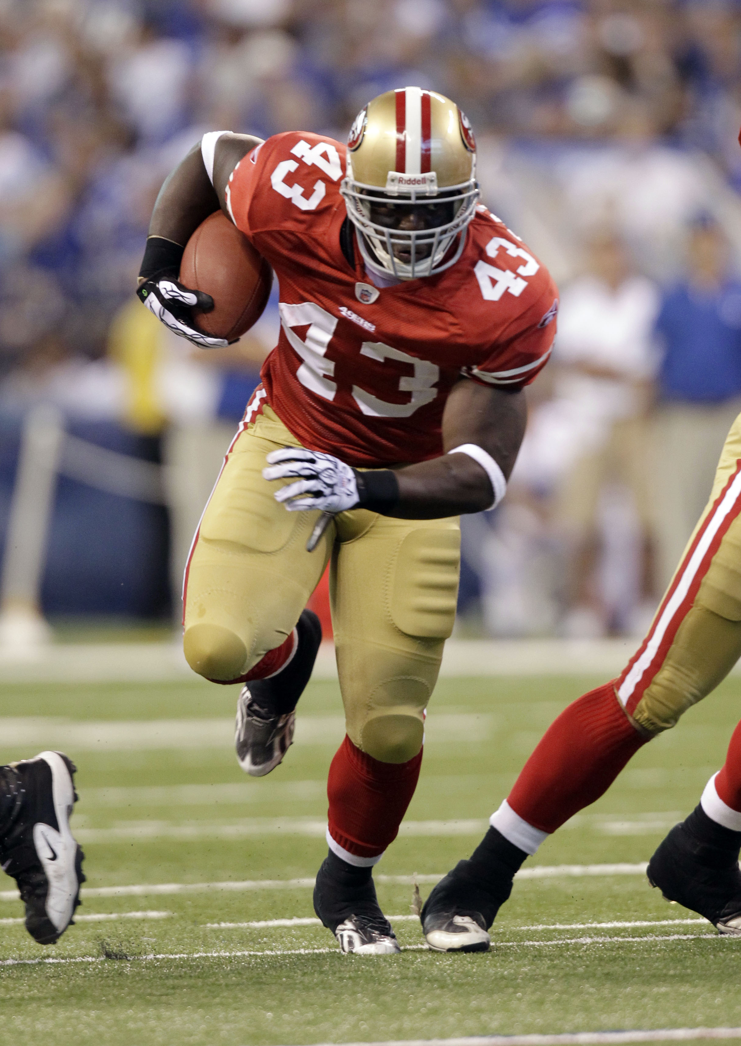 Jehuu Caulcrick #43 in 49ers home red running with the ball during preseason
